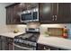Close-up of kitchen with stainless gas range, microwave, and modern backsplash at 1739 Lake Verona Cir, Bradenton, FL 34211