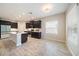 Well-lit kitchen with stainless steel appliances, dark cabinetry, and a spacious layout at 1739 Lake Verona Cir, Bradenton, FL 34211