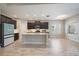 Contemporary kitchen boasts dark wood cabinets, a center island, and stainless steel appliances at 1739 Lake Verona Cir, Bradenton, FL 34211