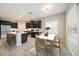 Modern kitchen featuring an island with barstool seating, dark cabinets, and stainless steel appliances at 1739 Lake Verona Cir, Bradenton, FL 34211