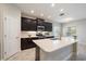 Stylish kitchen with dark cabinetry, quartz countertops, modern appliances, and a tile backsplash at 1739 Lake Verona Cir, Bradenton, FL 34211