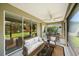Covered lanai with ample seating and view of the back yard at 1739 Lake Verona Cir, Bradenton, FL 34211