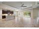 Open-concept living room with tile floors, ceiling fan and sliding doors to the backyard at 1739 Lake Verona Cir, Bradenton, FL 34211