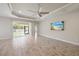 Bright living room with tile flooring, ceiling fan, and sliding glass doors to outdoor living space at 1739 Lake Verona Cir, Bradenton, FL 34211