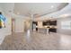 Spacious living room featuring an open floor plan and an adjacent kitchen with stainless appliances at 1739 Lake Verona Cir, Bradenton, FL 34211
