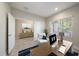 Bright home office with a large desk, an armchair, and an adjacent seating area with a dresser at 1739 Lake Verona Cir, Bradenton, FL 34211