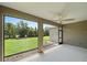 The screened-in patio offers views of the lush, green backyard with mature trees at 1739 Lake Verona Cir, Bradenton, FL 34211
