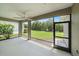 An expansive screened-in patio with a ceiling fan and access to the beautiful, green backyard at 1739 Lake Verona Cir, Bradenton, FL 34211