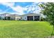 Lush backyard with a well-manicured lawn and a view of the home's covered patio, perfect for outdoor living at 17726 Gulf Ranch Pl, Lakewood Ranch, FL 34211