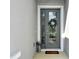 Inviting front entrance with a decorative wreath, glass door, and potted plants at 17726 Gulf Ranch Pl, Lakewood Ranch, FL 34211