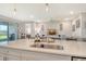 Spacious kitchen island with seating, opening to a living room area with a slider to an outdoor space at 17726 Gulf Ranch Pl, Lakewood Ranch, FL 34211