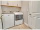 Convenient laundry room with a washer and dryer, overhead cabinets, and tiled flooring at 17726 Gulf Ranch Pl, Lakewood Ranch, FL 34211