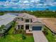 An aerial shot of a stunning two-story home with scenic water views and gorgeous landscaping at 17904 Palmiste Dr, Bradenton, FL 34202