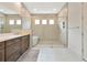 Spa-like bathroom with double vanity, soaking tub, and large glass-enclosed shower at 17904 Palmiste Dr, Bradenton, FL 34202