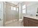 Modern bathroom with a glass-enclosed shower, stylish vanity, and large mirror at 17904 Palmiste Dr, Bradenton, FL 34202