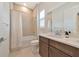 Well-lit bathroom featuring a shower over the tub and vanity with shaker cabinets at 17904 Palmiste Dr, Bradenton, FL 34202