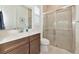 Well-lit bathroom featuring a walk-in glass shower, modern vanity, and a large mirror at 17904 Palmiste Dr, Bradenton, FL 34202