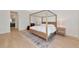 Bright bedroom with a four poster bed and hardwood floors, complemented by a neutral color palette at 17904 Palmiste Dr, Bradenton, FL 34202