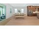 Bright dining area with a wooden table and bench, adjacent to a modern kitchen with stainless steel appliances at 17904 Palmiste Dr, Bradenton, FL 34202