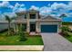 Beautiful two-story home boasting manicured landscaping, a paver driveway, and a welcoming front entrance at 17904 Palmiste Dr, Bradenton, FL 34202