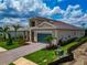 Well-maintained single-Gathering home featuring beautiful landscaping and a paver driveway leading to a two-car garage at 17904 Palmiste Dr, Bradenton, FL 34202