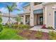 Inviting front porch with tasteful landscaping leading to the home's entrance and a cozy seating area at 17904 Palmiste Dr, Bradenton, FL 34202