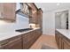 Well-equipped kitchen featuring modern appliances, quartz countertops, and stylish herringbone backsplash at 17904 Palmiste Dr, Bradenton, FL 34202