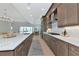Bright open kitchen with a large island, modern appliances, and a view to the dining area and outdoors at 17904 Palmiste Dr, Bradenton, FL 34202