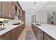 Modern kitchen featuring wood cabinets, quartz countertops, stainless steel appliances, and stylish decor at 17904 Palmiste Dr, Bradenton, FL 34202