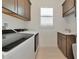 Functional laundry room featuring a sink and ample storage for convenience at 17904 Palmiste Dr, Bradenton, FL 34202
