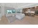 Open-concept living room and kitchen featuring lots of seating, natural light, and modern fixtures at 17904 Palmiste Dr, Bradenton, FL 34202