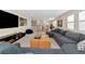 Bright, carpeted living room with a comfortable sectional sofa and large entertainment center at 17904 Palmiste Dr, Bradenton, FL 34202