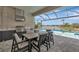 Outdoor kitchen and dining area featuring a grill and a picturesque view of the pool and lake at 17904 Palmiste Dr, Bradenton, FL 34202