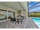 This covered outdoor kitchen features a stainless steel grill and dining area, perfect for entertaining at 17904 Palmiste Dr, Bradenton, FL 34202