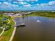 Aerial view of a pond with a fountain, dock and landscaped walking trail at 17904 Palmiste Dr, Bradenton, FL 34202