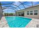 Resort-style pool and spa with screened enclosure and a view of the lush greenery at 17904 Palmiste Dr, Bradenton, FL 34202