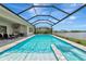 Screened pool area with a spillover spa offering a relaxing outdoor experience at 17904 Palmiste Dr, Bradenton, FL 34202