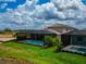 An aerial view featuring a screened pool area, tropical landscaping, and lush greenery in the backyard at 17904 Palmiste Dr, Bradenton, FL 34202