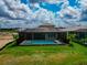 An aerial view showcasing a screened-in pool area with ample green space and a well-maintained backyard at 17904 Palmiste Dr, Bradenton, FL 34202