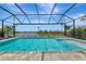 Beautiful pool with lake view and screen enclosure for enjoying the outdoors at 17904 Palmiste Dr, Bradenton, FL 34202
