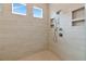Luxurious walk-in shower with multiple shower heads and built-in shelving at 17904 Palmiste Dr, Bradenton, FL 34202