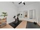 Bright workout room featuring exercise equipment, mirrors, and a view to the staircase at 17904 Palmiste Dr, Bradenton, FL 34202