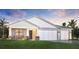 Charming single-story home featuring a two-car garage, well-manicured lawn, and a welcoming front porch at 18428 Dayspring Pl, Venice, FL 34293