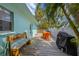 Outdoor back deck features a grill, dining table and bench, great for entertaining and relaxation at 205 71St St # B, Holmes Beach, FL 34217