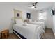 Charming bedroom with two twin beds, wood-look floors, nautical decor, and a ceiling fan for added comfort at 205 71St St # B, Holmes Beach, FL 34217