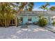 Charming, light-blue single-story home featuring a landscaped yard with white pebbles and an inviting front porch at 205 71St St # B, Holmes Beach, FL 34217