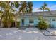 Adorable light-blue home with tropical landscaping, a cozy front porch, and inviting curb appeal at 205 71St St # B, Holmes Beach, FL 34217