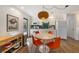 Bright kitchen area featuring white cabinets, a turquoise backsplash, and a modern dining set, perfect for cozy meals at 205 71St St # B, Holmes Beach, FL 34217