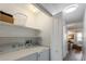 Bright laundry room features modern washer and dryer with functional shelving for organized storage solutions at 205 71St St # B, Holmes Beach, FL 34217