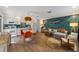 Open-concept living space with stylish decor, a fish accent wall, and a seamless flow into the modern kitchen at 205 71St St # B, Holmes Beach, FL 34217